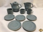 Joco com .. peças em porcelana Schmidt azul. Composto de bule, leiteira, açucareiro sem tampa, 2 xícaras de chá e 5 pires, pequeno bicado na leiteira e em uma da xícaras.