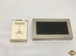 Lote composto de caixa retangular em prata 90 revestida de madeira e charutos Monte Cristo nº4. Medindo a caixa 21,5cm x 12cm x 4cm de altura.