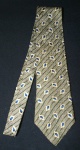 PERRY ELLIS - Portfolio -  Gravata em seda no padrão estampado com folhas, em tons de marrom, bege e azul. Med. maior: 10 cm.+