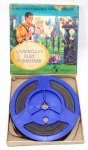 COLECIONISMO - DISNEY - Antigo filme em 8mm da série Cinderella - Fairy Godmother - de manufatura Disney acomodado em caixa original. Medindo a caixa 14cm de comprimento por 14cm de largura. Obs: não testado.
