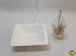 Lote composto de enfeite perfumado em vidro e petisqueira quadrada em porcelana. Medindo a petisqueira 15,5cm x 15,5cm x 4,5cm de altura.