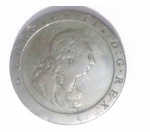 Moeda de cobre inglesa de 1797 com 36 mm de diâmetro e 28 gr (1 onça).A primeira moeda de cobre a circular na Grã-Bretanha , o "penny cartwheel" foi concebido para combater a falsificação . Projetado para pesar seu valor exato em cobre, ( uma onça ) , em 1797 o penny (centavo) era muito grande . No anverso apresenta a túnica laureado com o busto do rei George III virado para a direita. Na borda lê-se: ' GEORGIUS III- D: . G- REX "O reverso mostra Britannia sentada virada para a esquerda , segurando um ramo de oliveira e um tridente com um escudo que descansa ao lado , com um navio à distância. Na borda se lê "Britannia " acima e abaixo a data 1797.