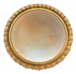 Bandeja circular em metal da manufatura alemã de WMF. Borda fundida com representações fitomórficas entre rocailles. Apresenta antiga douração com marcas e desgastes naturais do tempo. Alemanha. Final do séc. XIX. 47 cm. Pertencente ao acervo do Dr. Renato de Magalhães Gouvêa.