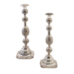 Par de castiçais em prata inglesa Sterling decorado em gomos com detalhes em espirais. Base quadrangular com chanfrados. Contraste de origem, leão rampante da cidade de Londres, de 1920 e punção do prateiro AD. 32 cm. 985 gramas (com enchimento).