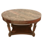 Mesa de apresentação estilo Império com tampo circular em mármore. Pernas lavradas com cariatides, apoiadas em base recortada e pés de bolacha. 46 x 91 cm. 