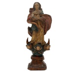 Nossa Senhora da Conceição - Imagem brasileira em madeira policromada e dourada representando Nossa Senhora da Conceição em sua tradicional postura com as mãos em oração. Base formada por cabeças de anjos, lua e nuvens. Peanha chanfrada Séc. XIX. 29 cm. 