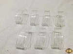 Jogo de 7 argolas de guardanapos em acrílico incolor. Medindo 6,5cm de comprimento.