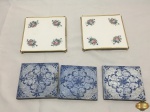 Lote com 5 descansos de panela, sendo 3 em madeira e 2 em cerâmica. Medindo os de cerâmica 16cm x 16cm.