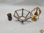 Lote composto de cinzeiro em vidro com acabamento em latão, enfeite de elefante e sineta de mesa em metal dourado. Medindo a sineta 11cm de altura.