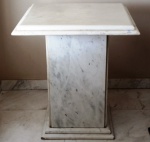 Mesa lateral de mármore branco, tampo quadrado apoiado em coluna também quadrada. Mede: 55 x 55 x 62 cm altura.(Lote encontra-se em Brasília, frete por conta do arrematante.)