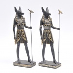 ANUBIS, par de estatuetas egípcias em material sintético policromado e dourado. Alt. 36cm