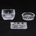 Lote composto por 03 cinzeiros confeccionados em cristal europeu  lapidados com padrões diversos. Med do maior: 10 x 10 x 5cm