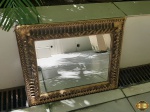 Espelho retangular em madeira trabalhada com patina ouro. Medindo a moldura 55cm x 44cm e o espelho 39,5cm x 29,5cm.