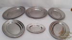 Baixelas 6 Peças  travesssas em Aço Inox  e Tramontina, sendo 1 Redonda e 5 Oval . Medidas: travessa redonda 35cm diametro , travessa oval grande 42cm de comprimento , travessa oval media 35cm de comprimento, travessa oval pequena 29cm de comprimento , travessa oval a menor 21cm de comprimento ,