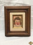 Quadro de óleo sobre eucatex de palhaço com moldura em madeira. Medindo a moldura 29,5cm x 25cm e a pintura 11cm x 8cm.