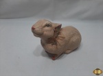 Enfeite de coelho em porcelana com policromia. Medindo 19,5cm de comprimento x 15cm de altura.