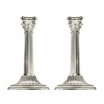Par de castiçais em metal banhado à prata de origem Italiana. Fuste canelado, capitel com detalhes incrustados e base quadrada. Exemplar antigo e em perfeito estado de conservação. Dimensões: 19 cm altura / Base 9 cm x 9 cm.