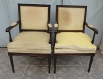 CONJUNTO COM DUAS CADEIRAS DE BRAÇO ELABORADA COM MADEIRA NOBRE - MADEIRA EM ÓTIMO ESTADO - COM ASSENTOS E ENCOSTO ESTOFADOS E FORRADOS COM TECIDO AMARELO COM MANCHAS ESPETACULARMENTE TACHEADOS NAS BORDAS DA FORRAÇÃO. TAM. 93 x 58 x 52cm.