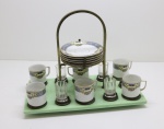 Conjunto de 6 xícaras de chá em porcelana da Bavária, policromadas com flores, suporte em base verde com 4 copinhos em cristal. Med. 25x32x17 cm.