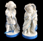 Duas esculturas em porcelana representando casal de crianças. 15 e 16 cm de altura.
