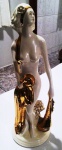 Maravilho grupo escultório de porcelana filetada a ouro representando ninfa  em riquíssimos detalhes. Mede: 40 cm