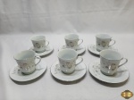 6 xícaras de chá, café com leite em porcelana Schmidt com flores brancas e friso prata nas bordas. Medindo a xicara 8,5cm de altura e o pires 15cm de diametro