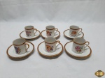 6 xícaras de cafézinho em porcelana francesa com pintura de flores e borda com desenho grego dourado. Medindo a xícara 5,5cm de altura e o pires 11,5cm de diametro.