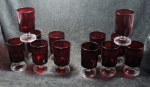 Doze cálices, vidro moldado, tonalidade rubi, manufatura francesa, marcados nos reversos das bases, <i>design</i> contemporâneo. 10,4cm. Íntegros.
