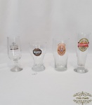 Lote de 4 copos  em vidro com logos de cervejas diversas.medida  maior 18 cm de altura, menor 13,5 cm de altura