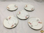 Lote de 5 pires de chá em porcelana Real friso ouro, flora. Medindo 14,5cm de diâmetro.