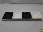 Lote composto de travessa com 4 petisqueira em porcelana preta e branca. Medindo as petisqueiras 10cm x 10cm.