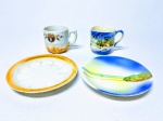 JAPAN- Elegante par de xícaras em fina porcelana japonesa, uma sendo com motivo praiano e outra com motivos florais predominante na cor branca e laranja. Ambas medem 4,5cm (xícaras) e 9,5cm (pires). Excelente estado de conservação.