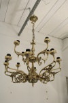 Lustre em bronze trabalhado com vazado, para 12 lâmpadas em dois andares de um com 8 braços e superior com 4 braços. Med. 60x60 cm.