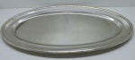 METAL ESPESSURADO A PRATA - Travessa oval em metal espessurado a prata. Med. 68x37 cm.
