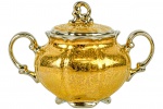 MAUÁ - Elegante Açucareiro, em fina porcelana toda em ouro com relevos e detalhes em prata; marca da manufatura na base. Dimensões: 10 cm X 9 cm (Alt./Diâm.). xxv