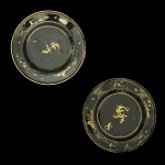 Raro par de pratos em vidro decorado com ouro, elementos vegetais e dragão ao centro. China, Qing, Qianlong (1736-1795). 23 cm de diâmetro. (Um apresenta bicados na borda). (Devido a fragilidade desse lote, seu envio só será realizado através de transportadora especializada).