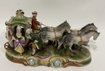 Grupo escultórico em porcelana Européia com imagem de Carruagem e personagens (Obs. falta 1 das patas do cavalo). 31 x 11 x 18 cm de altura.