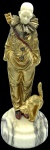 G. OMERTH (1895-1925). Pierrot com gato. Escultura de bronze com rosto em marfim. Base de mármore medindo 10 x 8,5 cm. 20 cm de altura (escultura) e 23 cm de altura total. Assinado