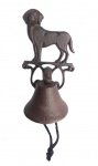 Campainha de sino em ferro fundido com figura de cão ao topo.