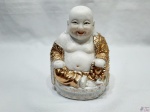 Escultura de Buda sentado sorrindo em porcelana com ouro. Medindo 17cm de altura.