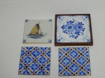 Quatro azulejos pintados à mão, um holandês com cena de barco, 13 x13cm; dois geométricos azul e marrom, 13 x 13cm; e um emoldurado com decoração floral azul e branca, 15 x 15cm.