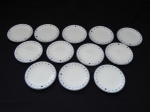 Doze porta-copos em porcelana alemã, decorados na borda sob a forma de bússola. Marcados no fundo Selmans Weiden, confeccionados como souvenires para a TAM Linhas Aéreas. Diâm. 10cm.