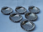 Seis tigelas para casquinha de siri em metal inox, moldados na forma de conchas. Marcado N inox. 2 x 11 x 9cm.
