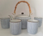 Conjunto de Bule e 04 xícaras de chá sem alça em porcelana Branca, decoração em frisos azuis. Med.: Bule 14 cm de diâmeto x 10 cm de altura; Xícaras medindo 8 cm de altura