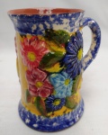 ANTIGA CANECA EM CERÂMICA PORTUGUESA RICAMENTE POLICROMADA COM DECORAÇÃO FLORAL. ALÇA COLADA. MEDINDO 10,5 X 9 CM