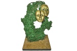 TOMMY - Belíssima Escultura, em bronze polido, representando Máscaras, sobre bronze bruto cinzelado, pintado na tonalidade verde, base em granito castanho. Dimensões: 45 cm X 34 cm (Alt./Larg.); Base: 25 cm X 26 cm (Comp./Larg.). Assinatura na lateral da máscara da esquerda. NÃO PODE SER DESPACHADA PELOS CORREIOS.