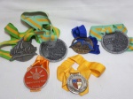 Seis medalhas de diversas competições, 2 do evento Pedalar 2014, 1 da competição 10 Milhas, 1 da corrida de São Sebastião ano de 2006, 1 do colégio Santo Inácio e 1 da Búzios Sailing Week 2009. a mair medindo 7,5cm