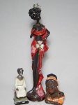 ARTE AFRO - Três esculturas em estuque policromado: uma alta representando mulher em trajes vaidosos, alt. 43cm; uma representando escrava Anastácia, alt. 16cm; e uma representando mulher, alt. 14cm.