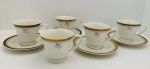 Porcelana Schmidt, Ivory China  Cinco xícaras para chá e quatro pires em porcelana na tonalidade marfim, borda com detalhes em ouro e decorada com flores.
