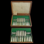 MAPPIN & WEBB - Faqueiro da manufatura inglesa, em metal prateado e rematado por cabos em madrepérola. Constando de: 12 garfos e as facas. Acondicionado em estojo original, com chave. Inglaterra. Meados do séc. XX. Marca da Casa Mappin & Webb Princes Plate. Reg. 71552